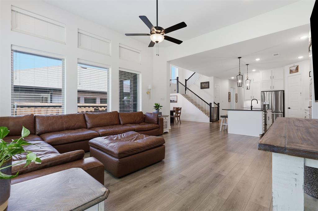 15413 Short Rdg Lane Fort Worth, TX 76008 - Photo 18 of 39 Open-concept living space featuring wood-finish flooring, high ceilings, and an integrated kitchen