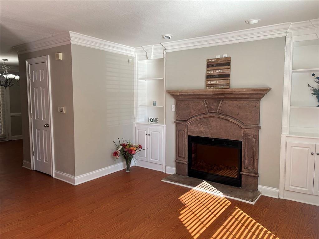 4430 Tilly Mill Road, Unit 104 Dunwoody, GA 30360 - Photo 18 of 37 a living room with furniture and a fireplace