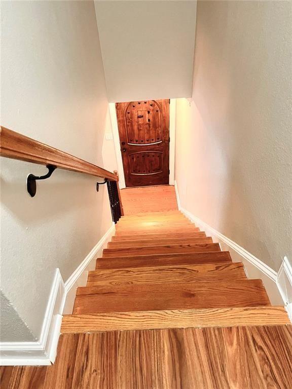 4430 Tilly Mill Road, Unit 104 Dunwoody, GA 30360 - Photo 25 of 37 a bedroom with a bed and wooden floor