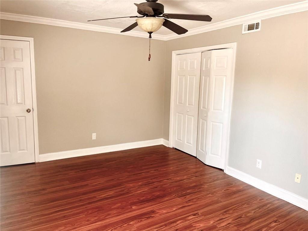 4430 Tilly Mill Road, Unit 104 Dunwoody, GA 30360 - Photo 32 of 37 a view of an empty room with wooden floor and a window