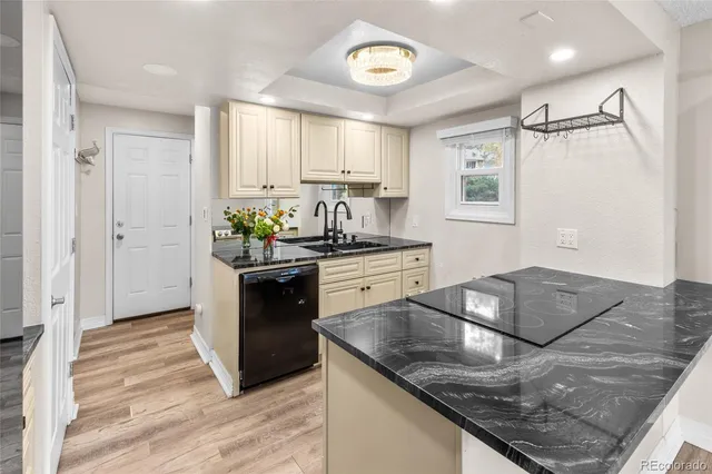 a kitchen with stainless steel appliances granite countertop a sink a stove and a refrigerator