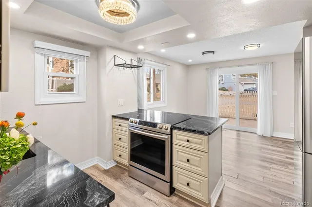 a kitchen with stainless steel appliances granite countertop a stove and a refrigerator