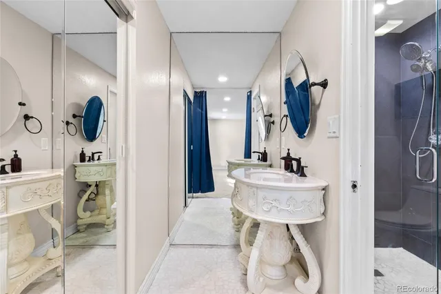 a bathroom with a sink a mirror a bathtub and shower