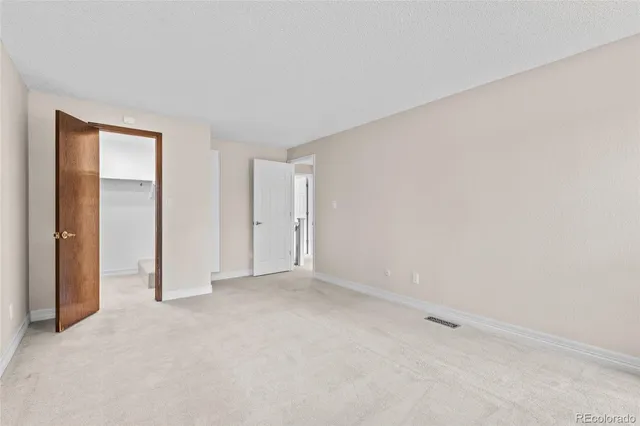 a view of an empty room and closet area