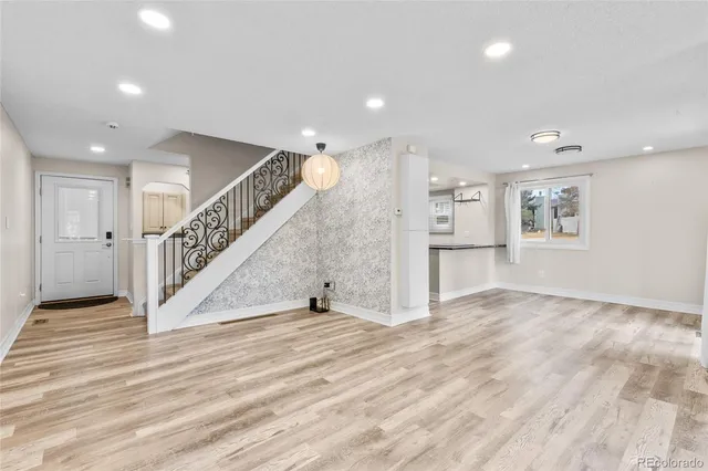 a view of empty room with wooden floor