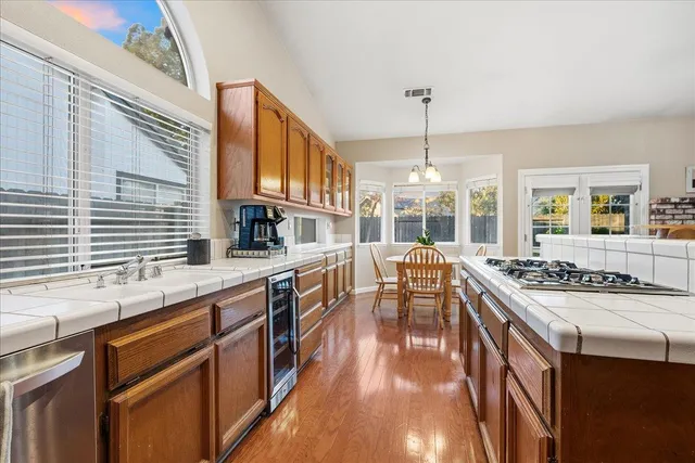 a kitchen with stainless steel appliances granite countertop a stove and cabinets