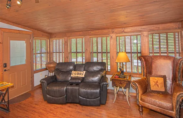 a living room with furniture and floor to ceiling windows