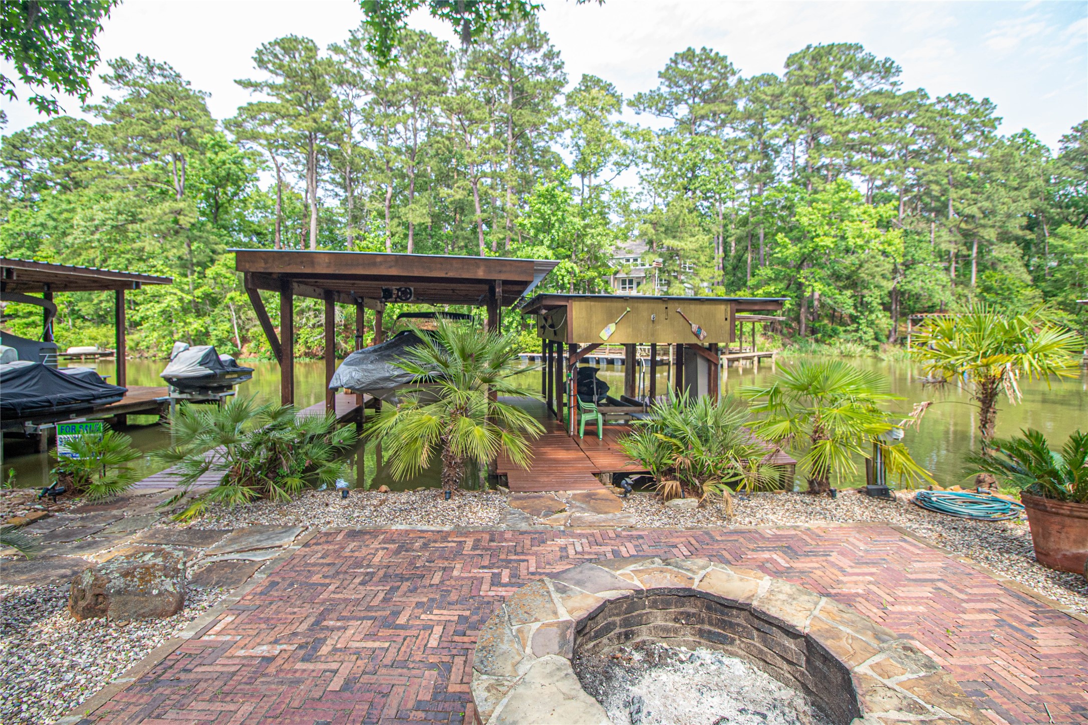 70 Lower Cove Drive Point Blank, TX 77364 - Photo 15 of 50 Another view. Solid brick fire pit setting at the water.