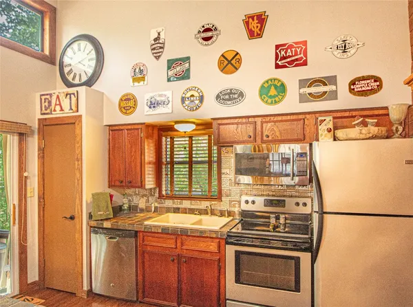 a kitchen with a refrigerator and a stove