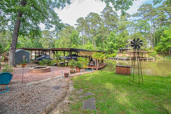 a view of a swimming pool with a patio and a yard