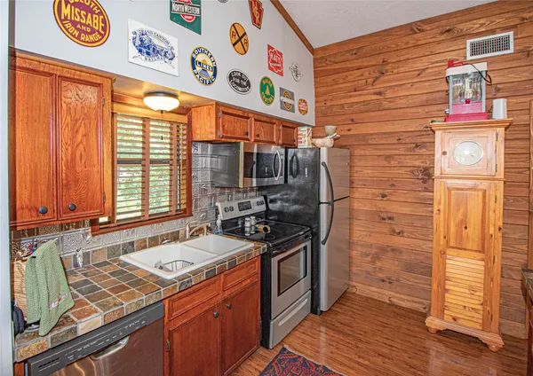a kitchen with stainless steel appliances granite countertop a stove and a refrigerator
