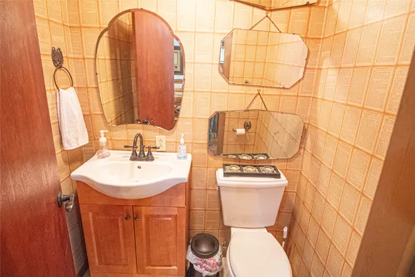 a bathroom with a toilet sink and mirror