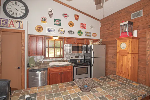 a kitchen with stainless steel appliances granite countertop a sink stove and refrigerator