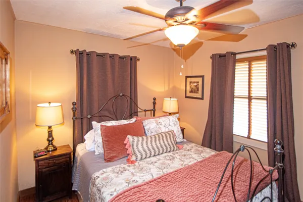 a bedroom with a bed and a chandelier