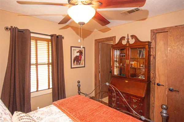 a bedroom with a bed dresser and a window