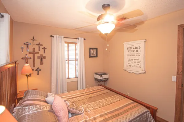 a bedroom with a bed and a chandelier