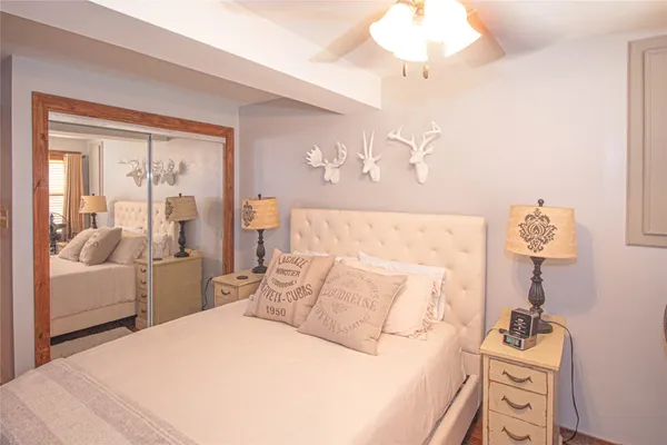 a bedroom with a large bed and a chandelier