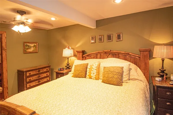 a bedroom with a bed and a chandelier