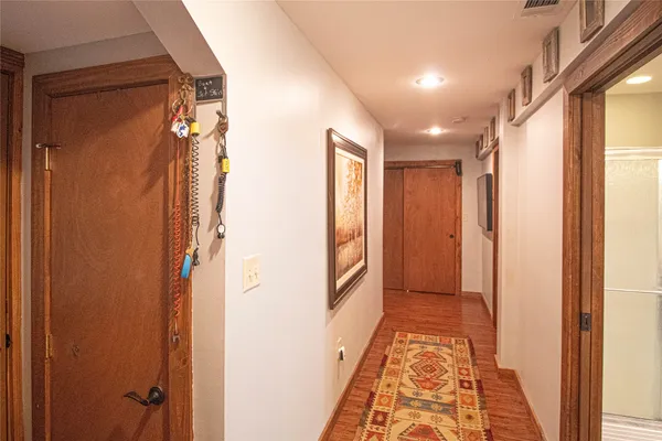 a view of hallway with a mirror and a shower