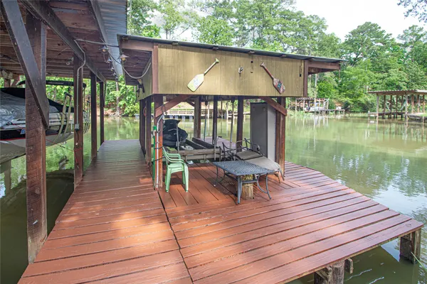 a view of a wooden deck with chairs