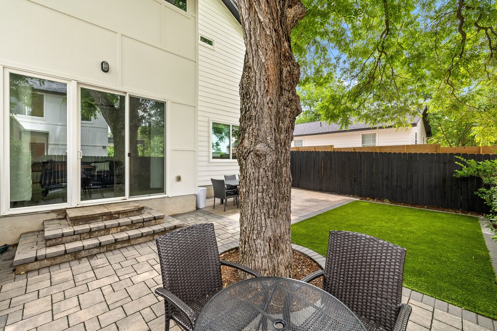 1182 Ridgeway Drive, Unit A Austin, TX 78702 - Photo 31 of 35 a view of a patio with a table chairs and a backyard