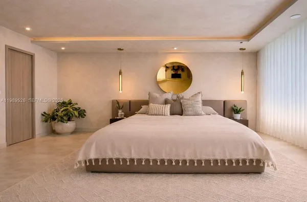 a bedroom with a bed and a potted plant