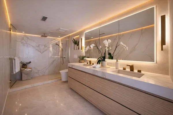 a bathroom with a double vanity sink mirror and shower