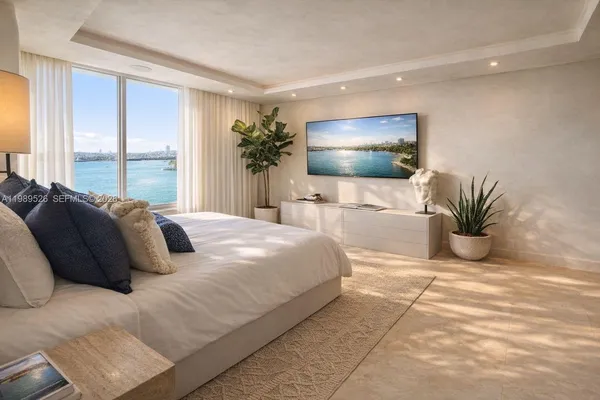a bedroom with a large bed and a flat screen tv
