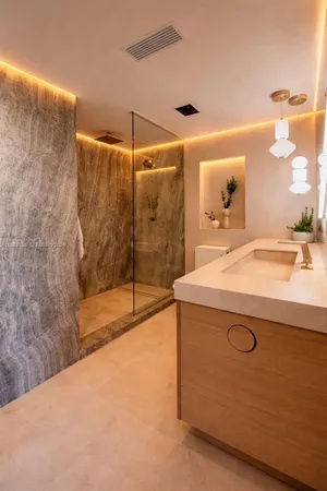 a bathroom with a sink a mirror and a shower