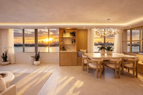 a dining room with furniture and a floor to ceiling window