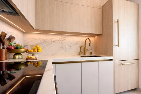 a kitchen with a sink and cabinets