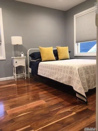 a bedroom with bed and a table