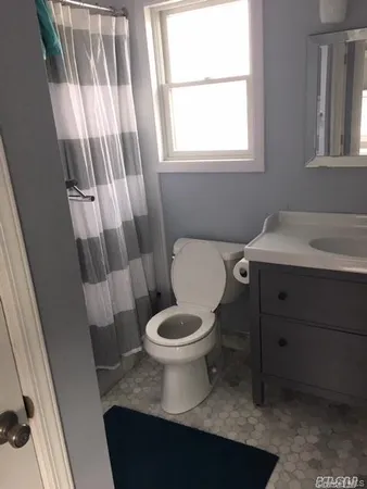 a bathroom with a toilet a sink and a mirror