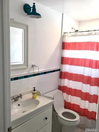 a bathroom with a sink and a window