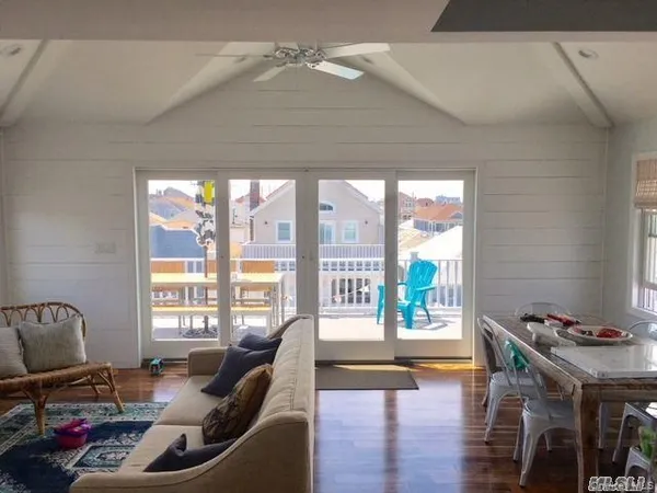 a living room with furniture and floor to ceiling windows