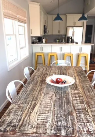 a kitchen with a sink a stove a dining table and chairs