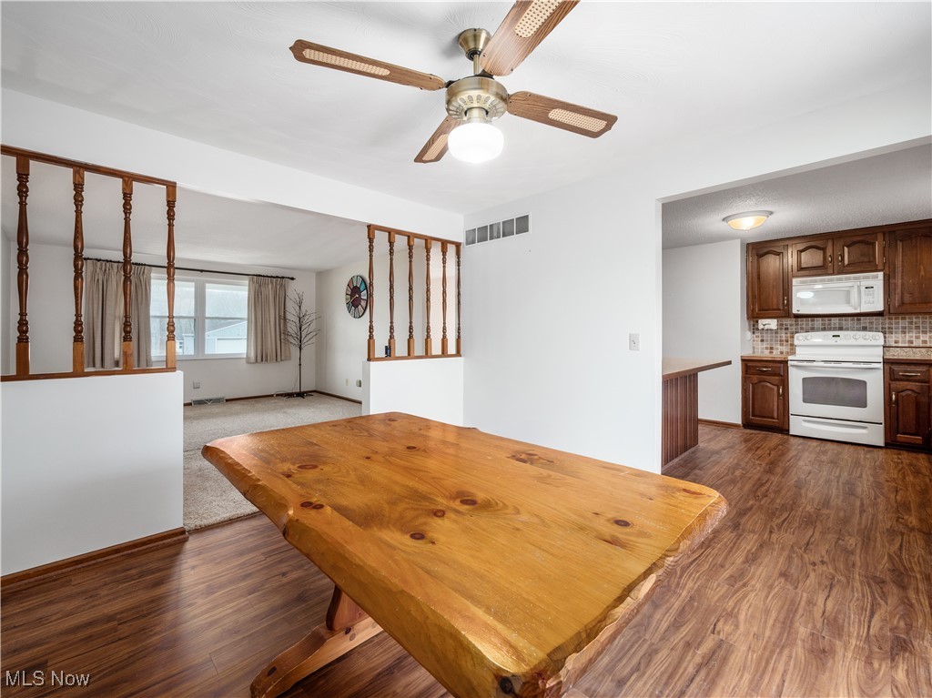 12454 Old Rainer Road Roseville, OH 43777 - Photo 14 of 33 Unfurnished dining area featuring dark hardwood / wood-style floors and ceiling fan