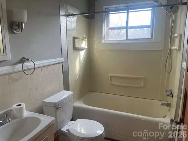 a bathroom with a toilet a sink and bathtub