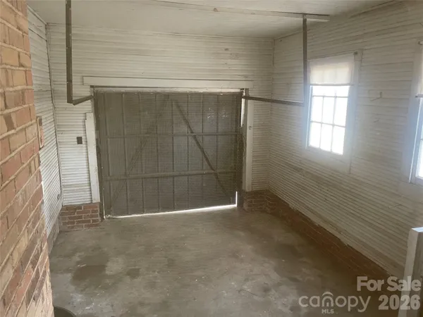 a view of a door and brick wall