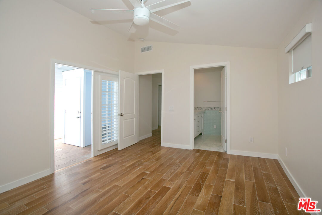 122 Montreal Street Playa del Rey, CA 90293 - Photo 14 of 30 an empty room with wooden floor and fan