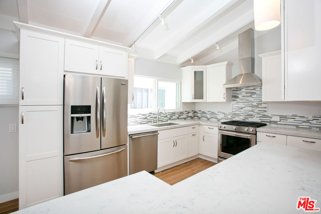 122 Montreal Street Playa del Rey, CA 90293 - Photo 9 of 30 a kitchen with granite countertop a refrigerator stove top oven and sink