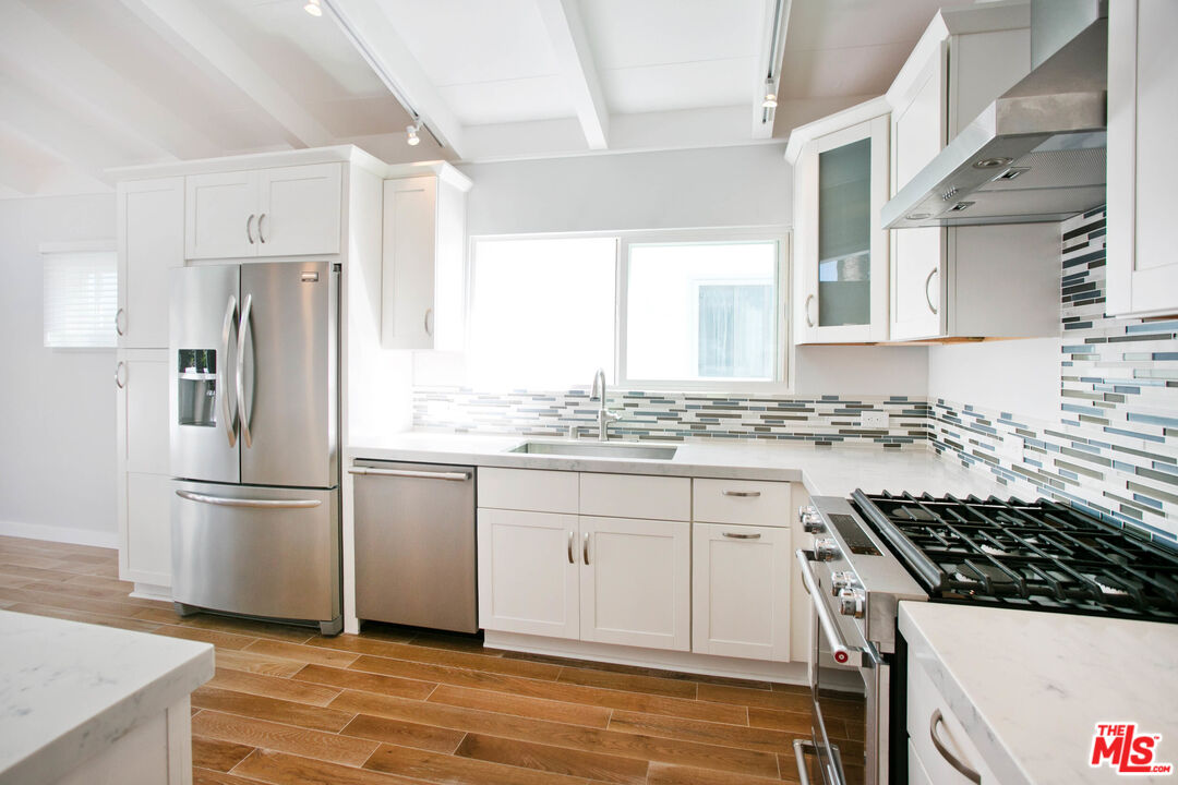 122 Montreal Street Playa del Rey, CA 90293 - Photo 10 of 30 a kitchen with granite countertop a sink stove and refrigerator
