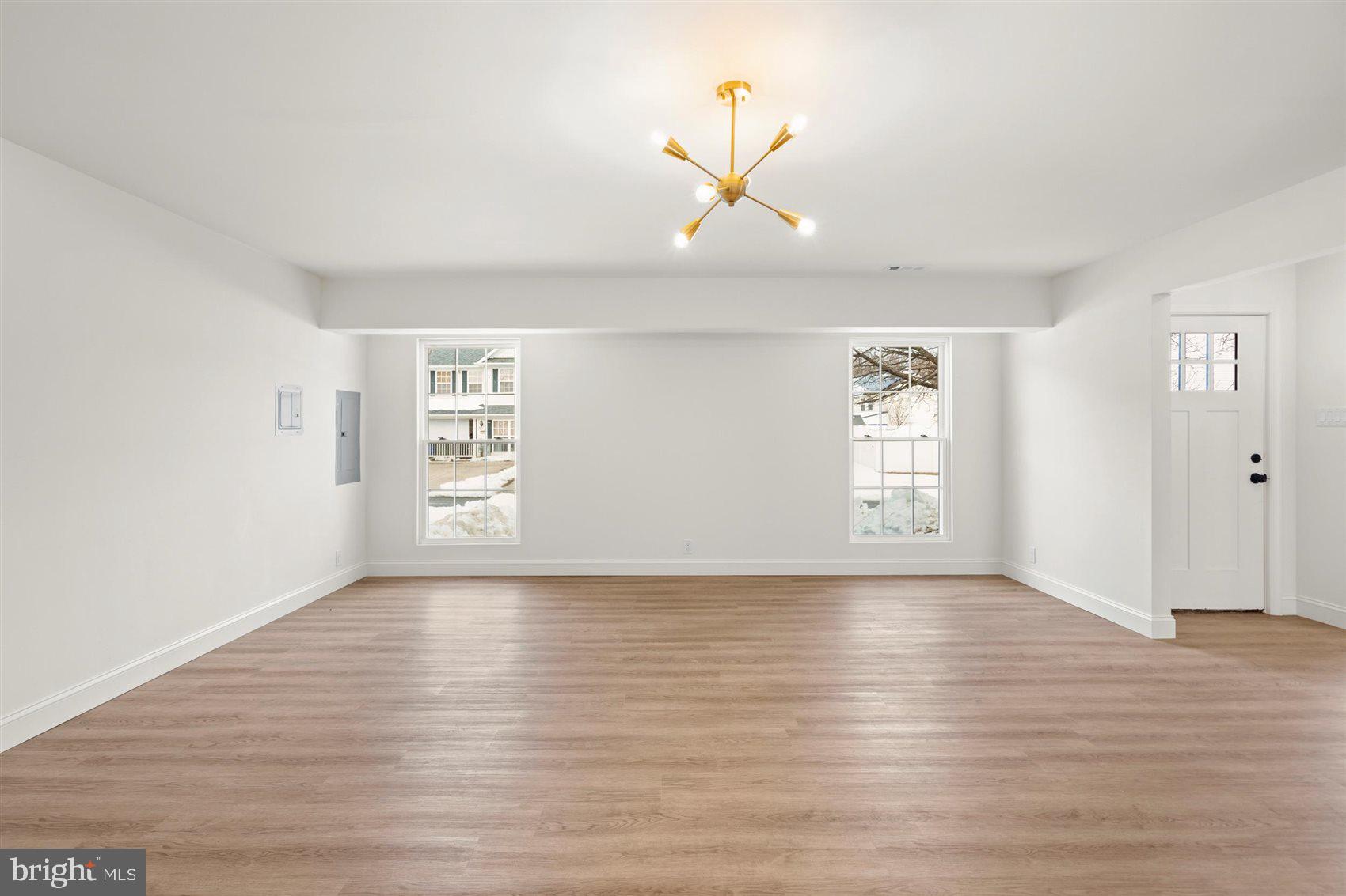 304 Canoe Lane Edgewood, MD 21040 - Photo 11 of 41 an empty room with wooden floor chandelier and windows