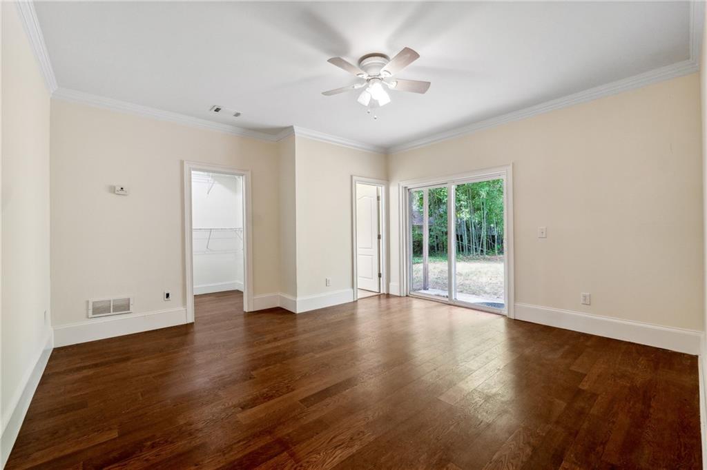 1303 North Druid Hills Road Brookhaven, GA 30319 - Photo 23 of 56 a view of an empty room with wooden floor and a window