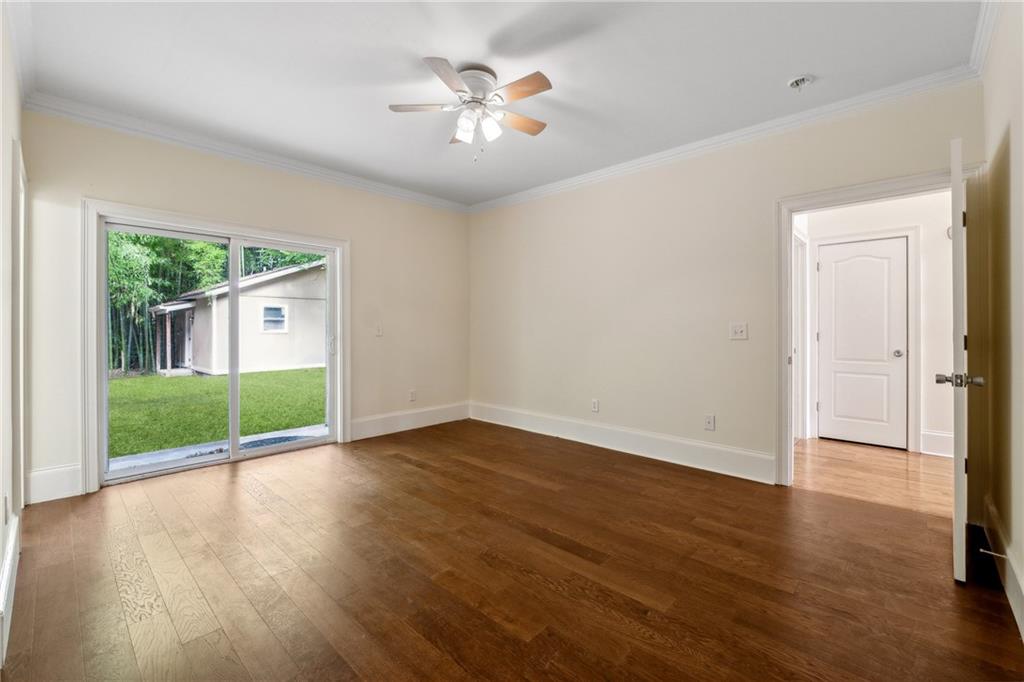 1303 North Druid Hills Road Brookhaven, GA 30319 - Photo 28 of 56 wooden floor in an empty room with a window