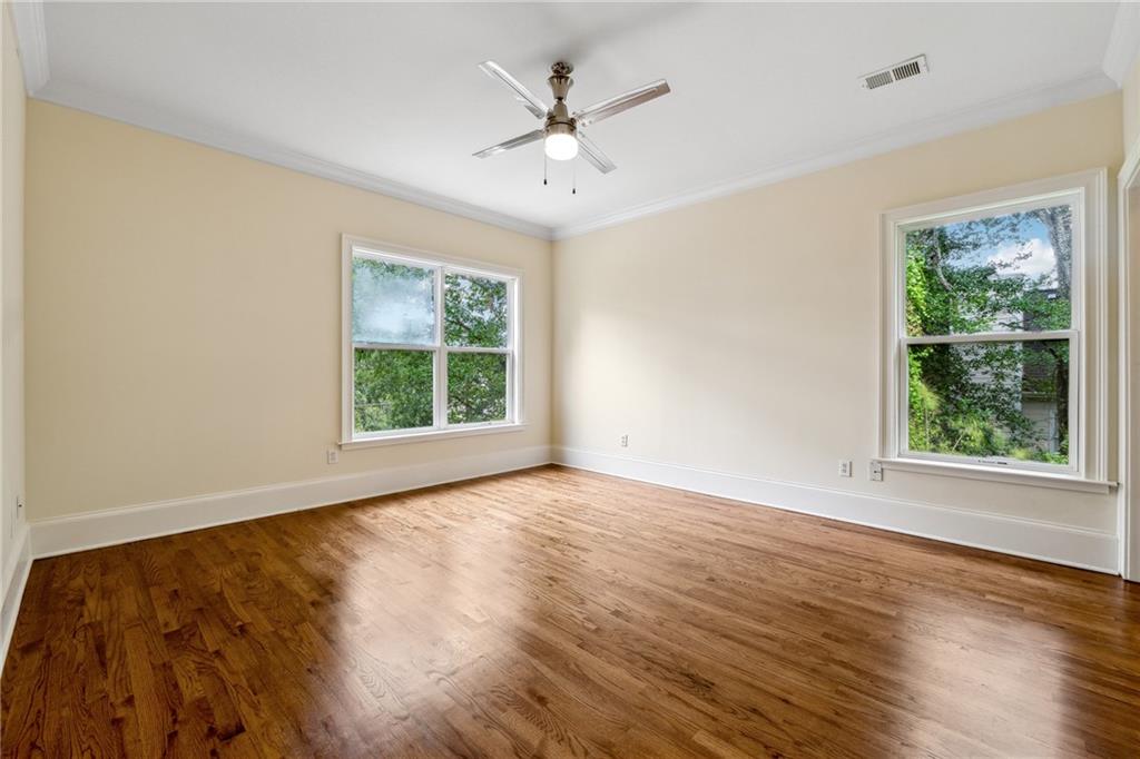 1303 North Druid Hills Road Brookhaven, GA 30319 - Photo 36 of 56 a view of an empty room with wooden floor and a window