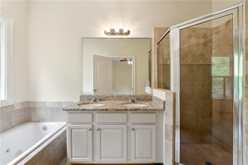 1303 North Druid Hills Road Brookhaven, GA 30319 - Photo 44 of 56 a bathroom with a granite countertop sink mirror and a bathtub