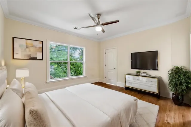 a bedroom with a large bed couch and a window