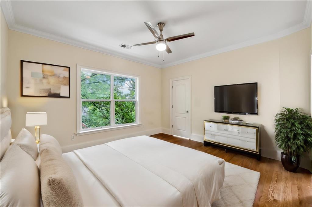 1303 North Druid Hills Road Brookhaven, GA 30319 - Photo 8 of 56 a bedroom with a bed and a flat screen tv