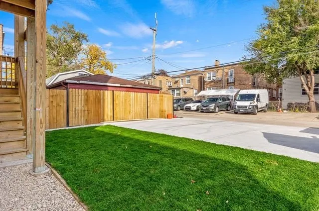 a yellow house with the garden in front of it
